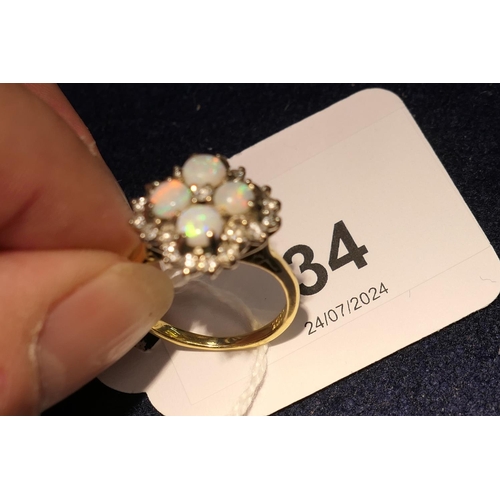 34 - Opal and diamond cluster ring, set with four cabochon round opals, centred and bordered with small b... 