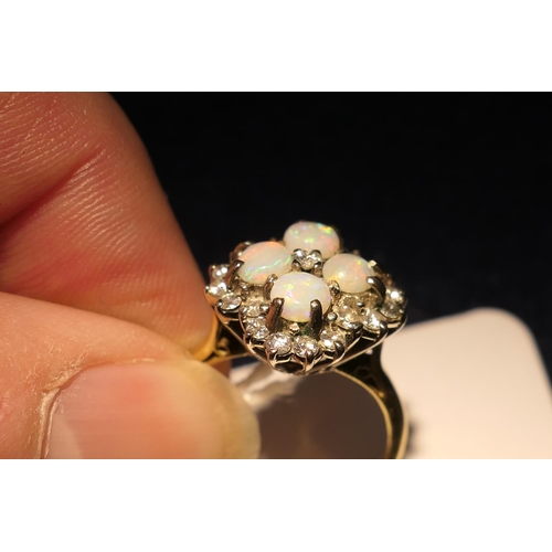 34 - Opal and diamond cluster ring, set with four cabochon round opals, centred and bordered with small b... 