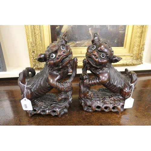 835 - Pair of Chinese carved hardwood Dogs of Fo, late 19th/early 20th Century, with original glass eyes, ... 