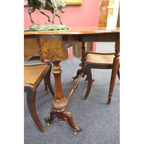 948 - Victorian burr walnut Sutherland table, quarter veneered shaped drop leaves over fluted baluster col... 