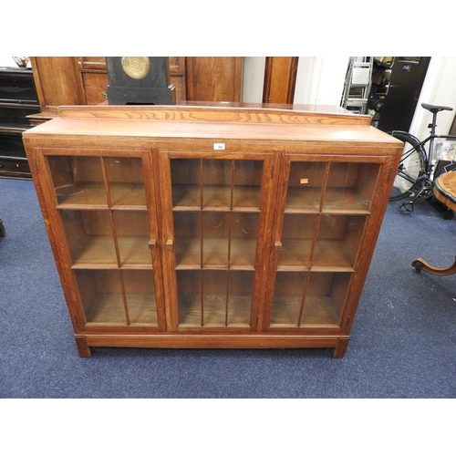 555 - Bryn Mawr oak 'Dwarf Gower' bookcase, having three glazed doors enclosing chamfered edge shelves, st... 