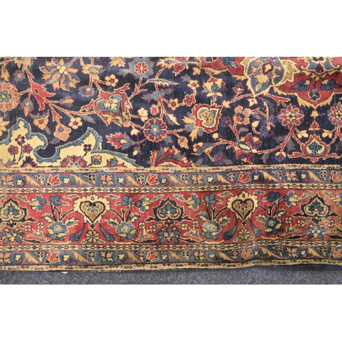 562 - Persian woollen rug late 19th Century (extensively worn), size 420cm x 180cm