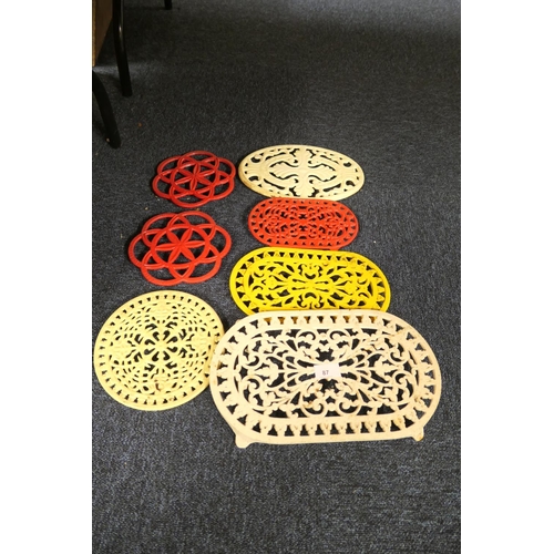 87 - Seven painted cast metal trivets