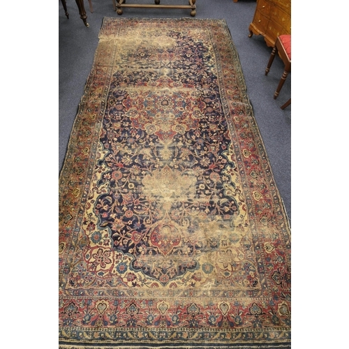 562 - Persian woollen rug late 19th Century (extensively worn), size 420cm x 180cm