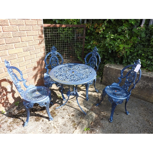 599 - Blue painted cast alloy garden suite comprising circular table and four chairs, the table 69cm diame... 