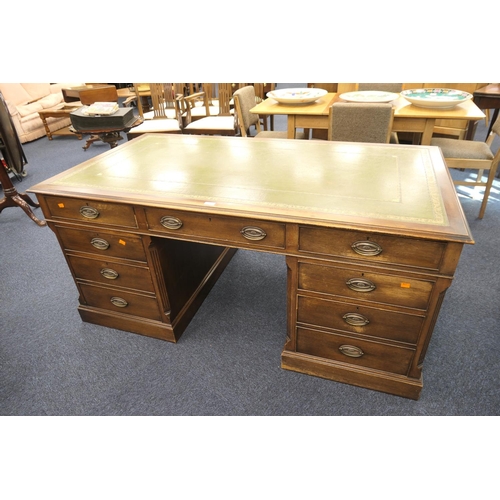 683 - Mahogany twin pedestal desk in the Georgian style, with green tooled leather inset, false drawers to... 