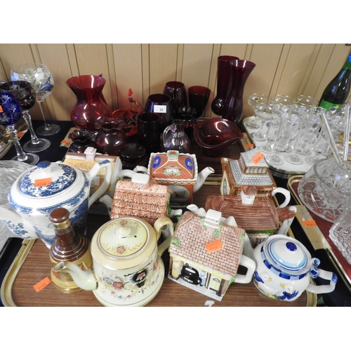 50 - Cranberry and ruby glassware, also a number of novelty and other teapots (2 trays)