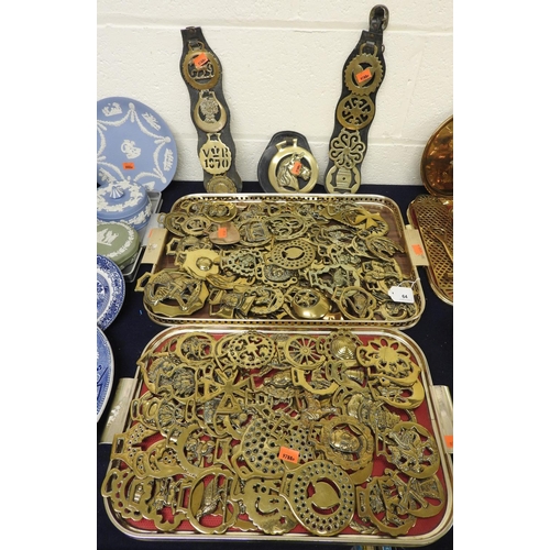 64 - Large quantity of Victorian and later horse brasses and including two martingales (2 trays)