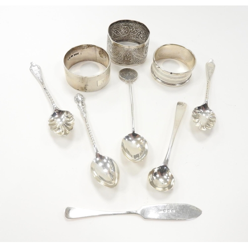 242 - Two silver napkin rings, also five silver spoons and a silver butter knife, weighable sterling silve... 