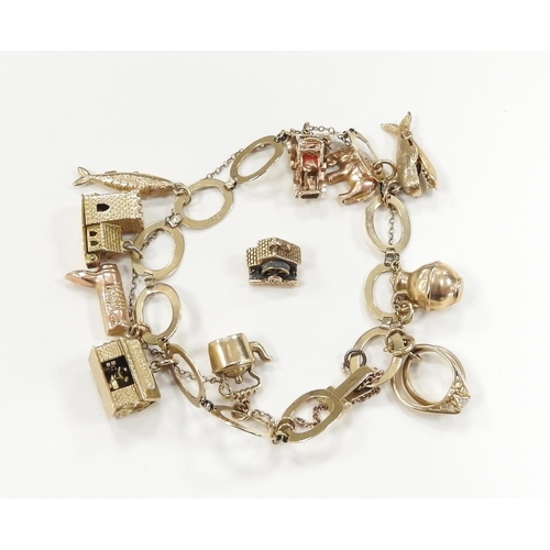 270 - 9ct gold oval link charm bracelet, supporting a number of 9ct gold charms, with safety chain, also a... 