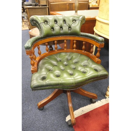 603 - Green leather upholstered swivel armchair