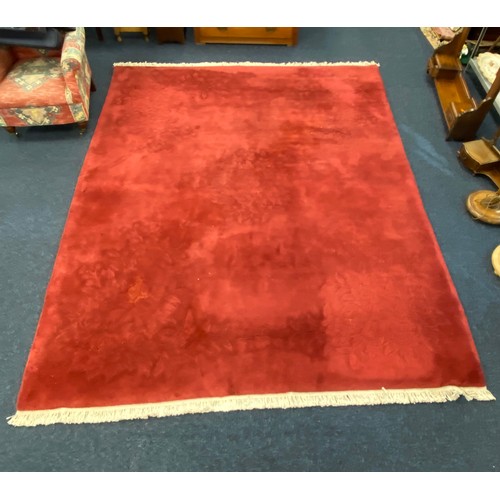 608 - Chinese claret ground sculpted woollen carpet, 310cm x 246cm