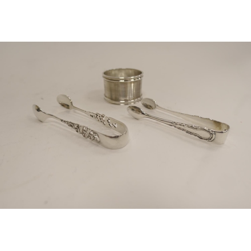 191 - Heavy silver napkin ring, Chester 1926 and two pairs of silver sugar tongs, Birmingham 1908 and Lond... 