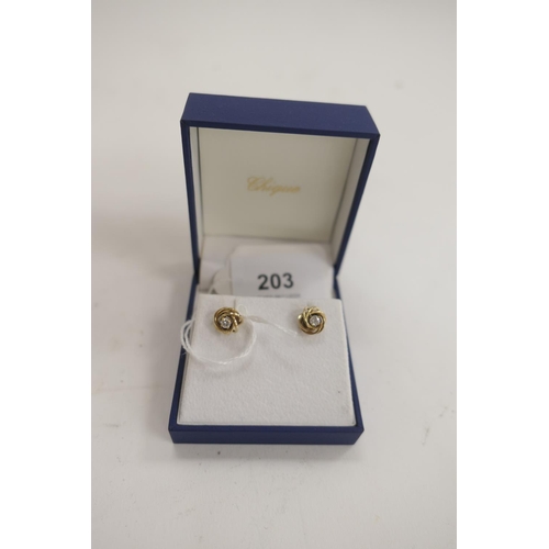 203 - Pair of diamond knot form ear studs in unmarked yellow gold, the diamonds estimated as approx. 0.1ct... 