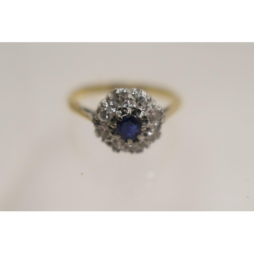 213 - Diamond and sapphire cluster ring, the central round cut sapphire of approx. 0.15ct, bordered with s... 