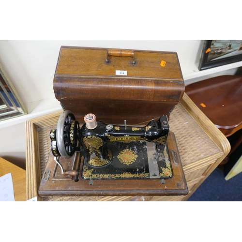 314 - Jones walnut cased sewing machine (lock detached)