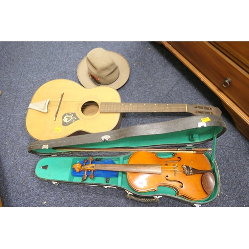 337 - Cased Chinese violin, also a student's guitar and an Australian hat, size 58 (3)