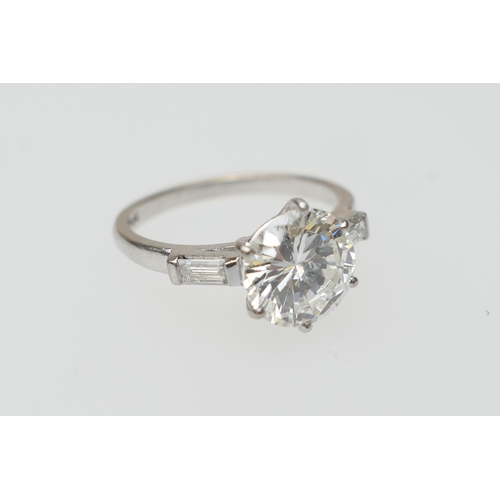 103 - Diamond three stone ring, centred with a round brilliant cut diamond of approx. 2.24cts, certificate... 