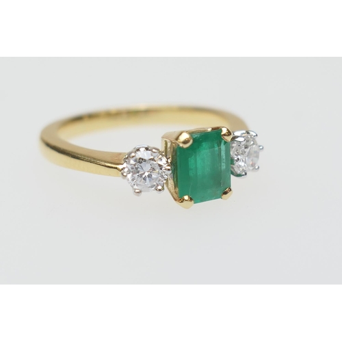 111 - Emerald and diamond three stone ring, the untested emerald of approx. 1ct, in a four claw mount, fla... 