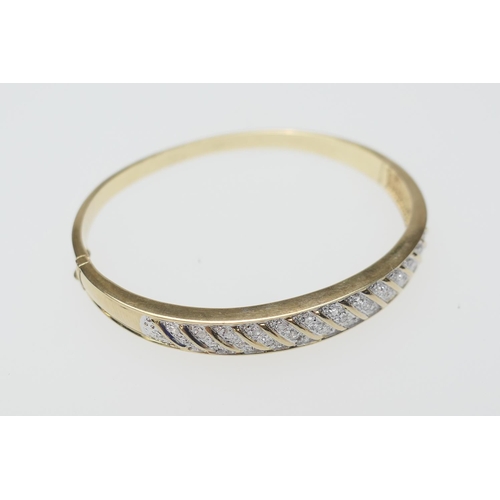 119 - Diamond pave yellow gold bangle, set with 33 tiny round cut diamonds, wrythen channel set in white g... 