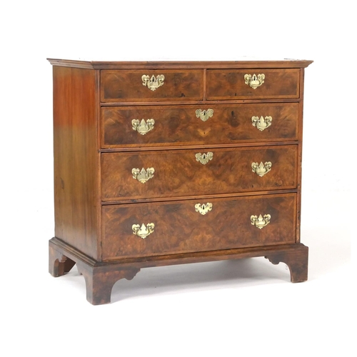 549 - Walnut chest of drawers, in part 18th Century with later restoration, fitted with two short and thre... 