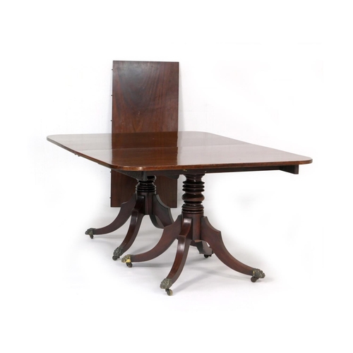 550 - Late Regency mahogany twin pedestal dining table, circa 1815-30, the top with rounded corners accomm... 