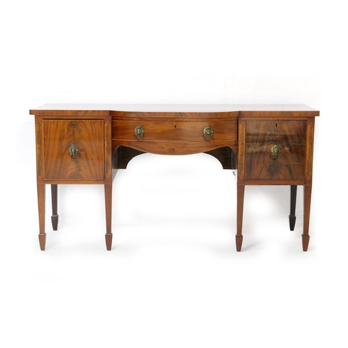 557 - Late George III mahogany and inlaid bow front sideboard, circa 1810-25, fitted with a central drawer... 