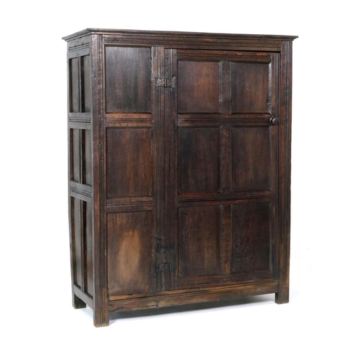 558 - Oak joined livery cupboard, mid 17th Century and later, having recessed panels with channel moulded ... 