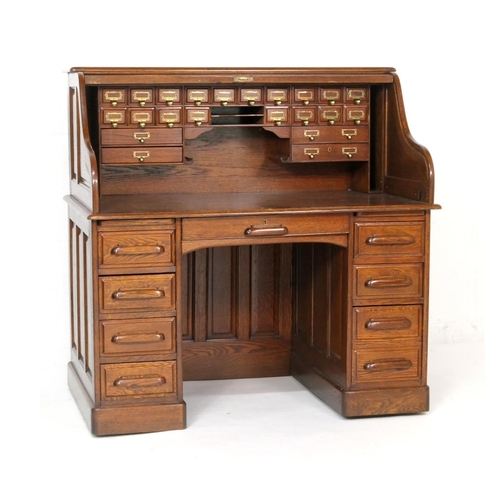 560 - Good oak tambour desk, fully fitted interior with a number of small drawers and longer drawers, with... 