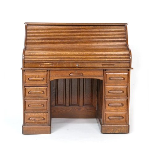 560 - Good oak tambour desk, fully fitted interior with a number of small drawers and longer drawers, with... 