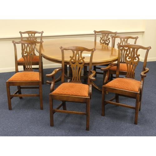 572 - Quality oak extending dining table together with six (4+2) Chippendale style oak dining chairs, by C... 