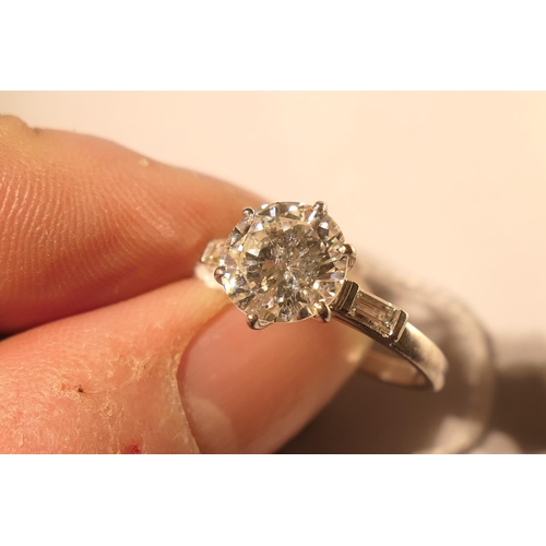 103 - Diamond three stone ring, centred with a round brilliant cut diamond of approx. 2.24cts, certificate... 