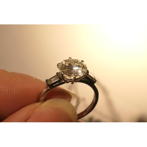 103 - Diamond three stone ring, centred with a round brilliant cut diamond of approx. 2.24cts, certificate... 