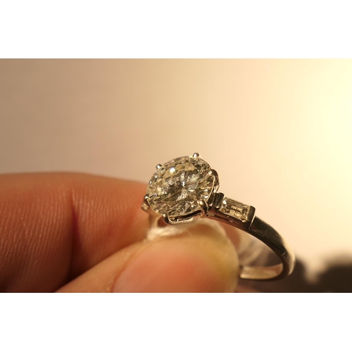 103 - Diamond three stone ring, centred with a round brilliant cut diamond of approx. 2.24cts, certificate... 