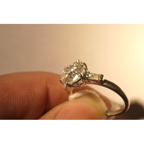 103 - Diamond three stone ring, centred with a round brilliant cut diamond of approx. 2.24cts, certificate... 