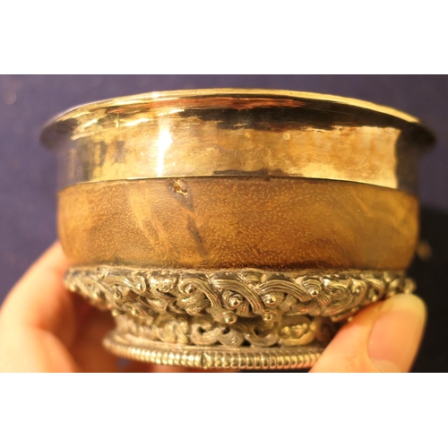 47 - Tibetan white metal mounted mazer bowl, late 19th Century, white metal lining, having an intricate b... 