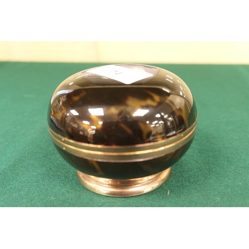 74 - Tortoiseshell bun form ring or powder box, hinged cover, mounted in gilt metal over a circular foot,... 