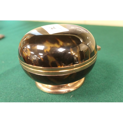 74 - Tortoiseshell bun form ring or powder box, hinged cover, mounted in gilt metal over a circular foot,... 