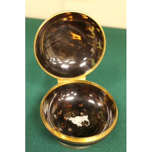 74 - Tortoiseshell bun form ring or powder box, hinged cover, mounted in gilt metal over a circular foot,... 