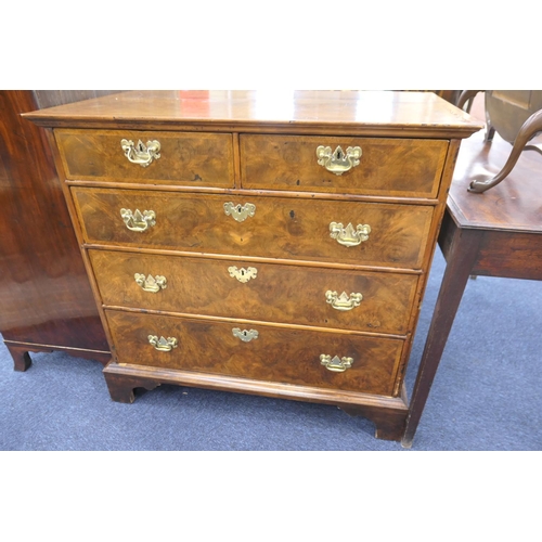 549 - Walnut chest of drawers, in part 18th Century with later restoration, fitted with two short and thre... 