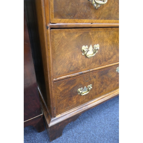 549 - Walnut chest of drawers, in part 18th Century with later restoration, fitted with two short and thre... 