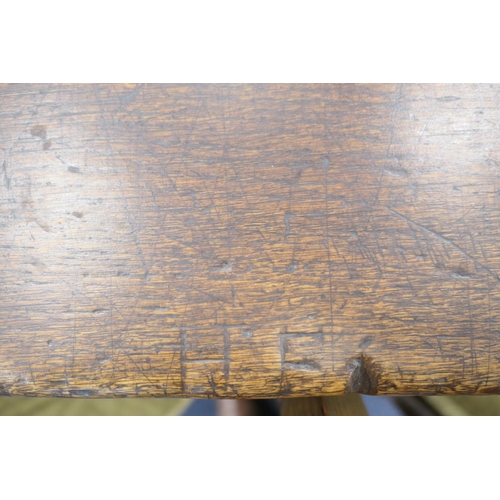 556 - Oak refectory table, Mid 17th Century and later, three plank top patinated and with some old graffit... 