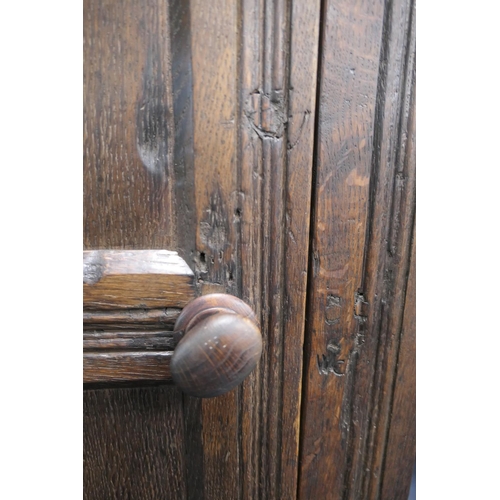 558 - Oak joined livery cupboard, mid 17th Century and later, having recessed panels with channel moulded ... 