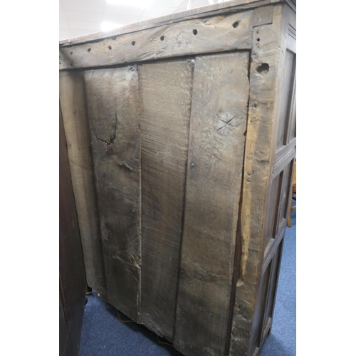 558 - Oak joined livery cupboard, mid 17th Century and later, having recessed panels with channel moulded ... 