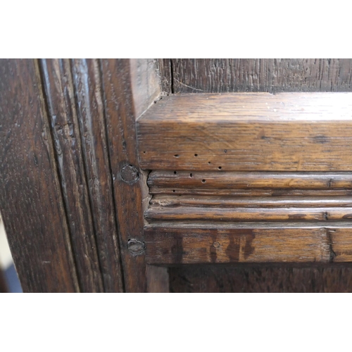 558 - Oak joined livery cupboard, mid 17th Century and later, having recessed panels with channel moulded ... 