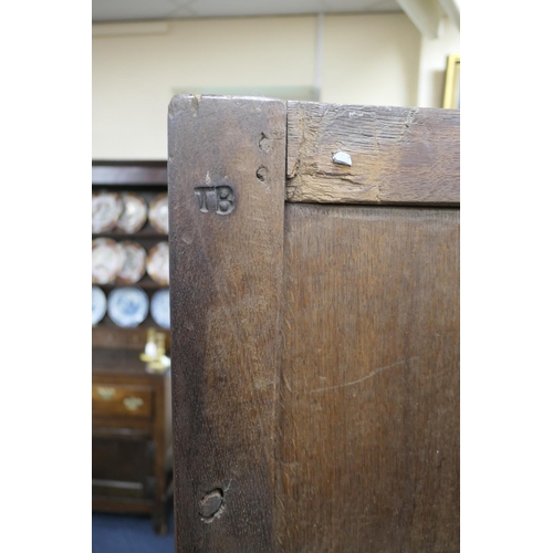 558 - Oak joined livery cupboard, mid 17th Century and later, having recessed panels with channel moulded ... 