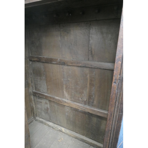 558 - Oak joined livery cupboard, mid 17th Century and later, having recessed panels with channel moulded ... 