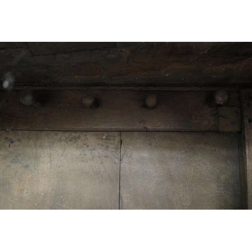 558 - Oak joined livery cupboard, mid 17th Century and later, having recessed panels with channel moulded ... 