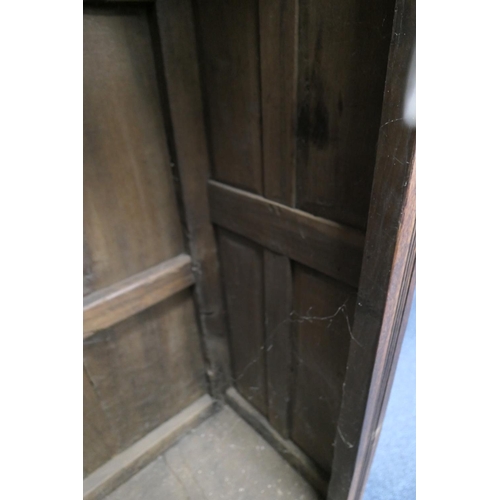 558 - Oak joined livery cupboard, mid 17th Century and later, having recessed panels with channel moulded ... 