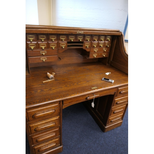 560 - Good oak tambour desk, fully fitted interior with a number of small drawers and longer drawers, with... 